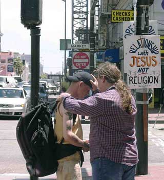 Paul  prays with man at UN Plaza on June 18