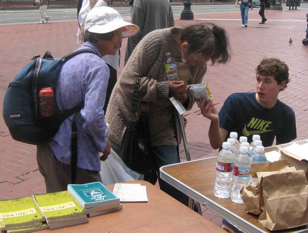 Ben gives food to women at U N Plaza.